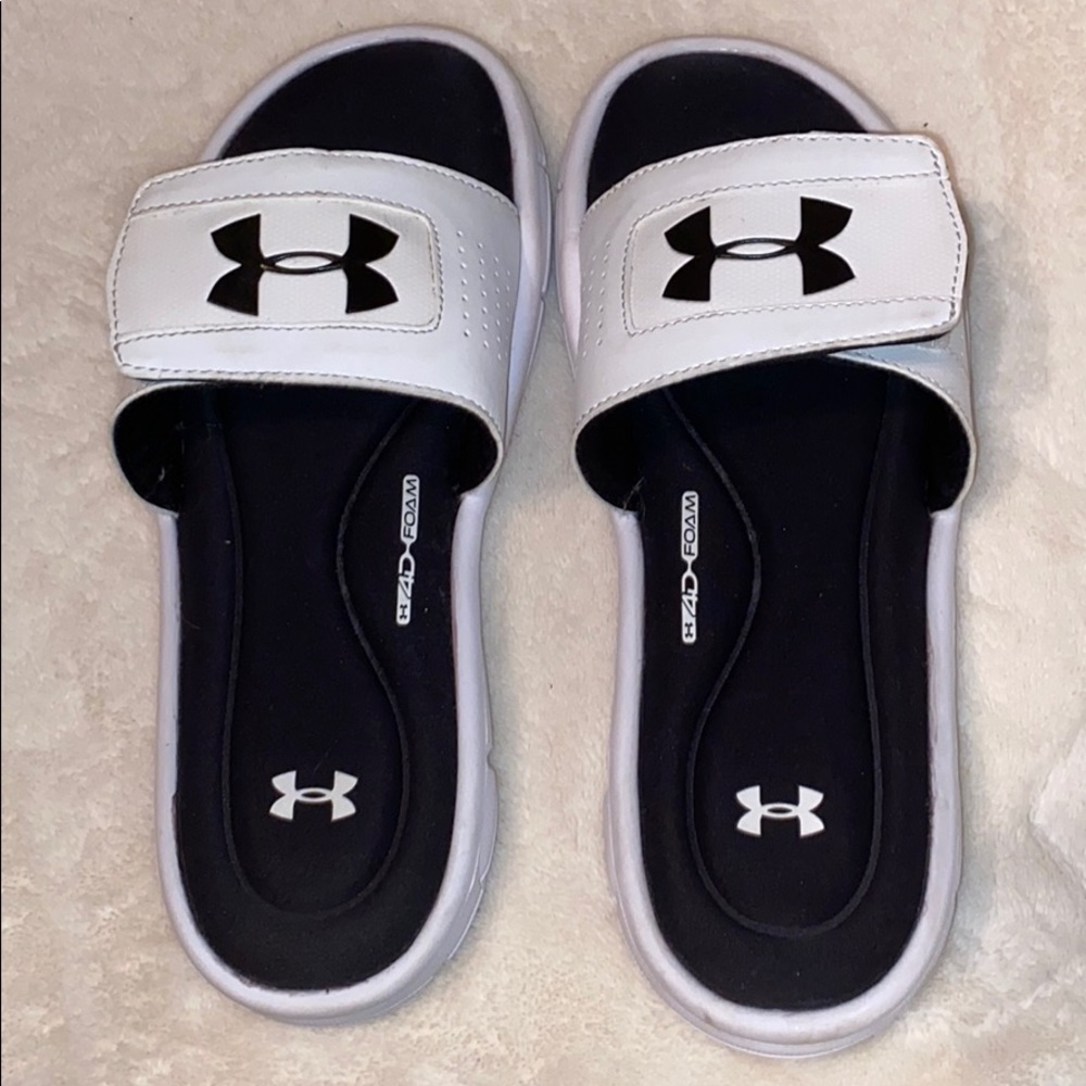 White and black Under Armour slides